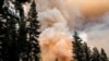 Western Wildfires Calm Down in Cool Weather, But Losses Grow 