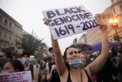 Demonstrators protest Friday, June 5, 2020, near the White House in Washington, over the death of George Floyd, a black man who was in police custody in Minneapolis. Floyd died after being restrained by Minneapolis police officers.