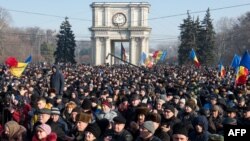 People attend the rally in front of the Parliament building in Chisinau on January 21, 2016. 
