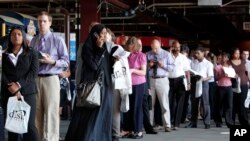 FILE – In this July 15, 2009, file photo, job seekers wait in line during a sixth annual "Grand Slam Career Fair" at Citizens Bank Park in Philadelphia. 