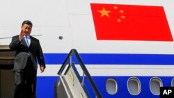 Chinese President Xi Jinping gestures as he arrived at Vladivostok, Russia, to attend the Eastern Economic Forum, Tuesday, Sept. 11, 2018. 