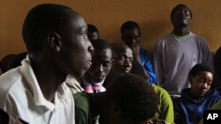 Teenage Orphans listen as officials explain that the Noel Orphanage will be downsized, and they will be relocated.