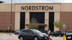 A lone shopper heads back to her vehicle near the Nordstrom department store in the Flatirons Crossing Mall in Broomfield, Colo., May 14, 2020. 