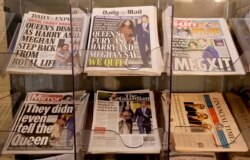Newspapers are seen for sale in London, Jan. 9, 2020. In a statement Prince Harry and his wife, Meghan, said they are planning "to step back" as senior members of the royal family and "work to become financially independent."