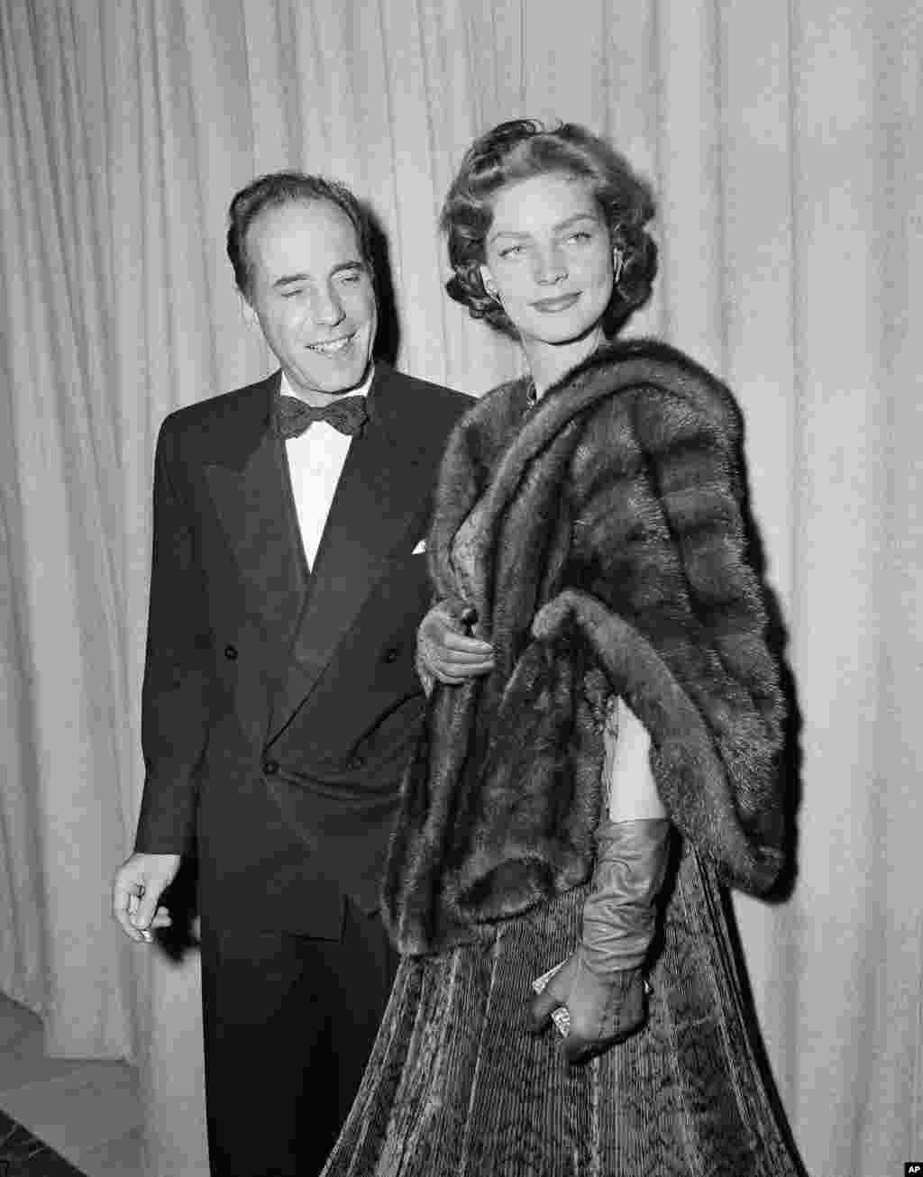 Humphrey Bogart and wife Lauren Bacall arrive for the Academy Awards ceremony in Hollywood, California, March 20, 1952.