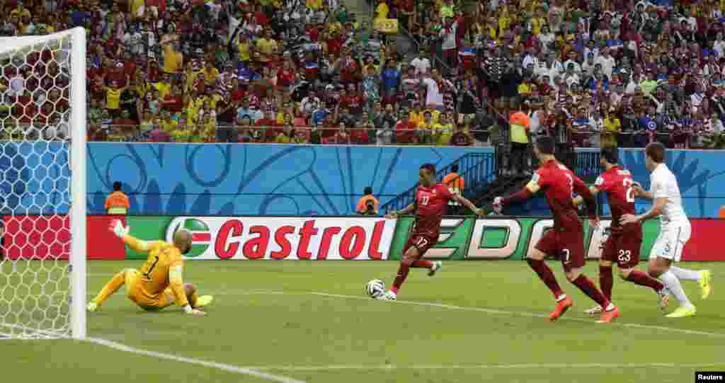 Portugal's Cristiano Ronaldo (7) watches teammate Nani (17) score a goal during their match between against the U.S. at the Amazonia arena in Manaus, June 22, 2014.
