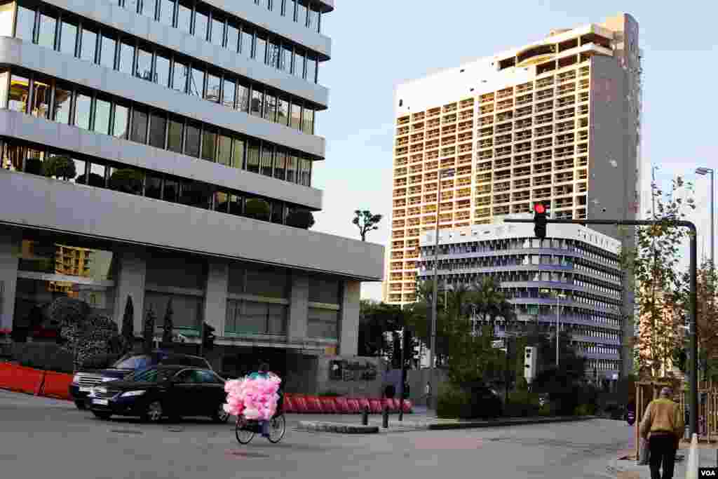 The scarred hulk of the old Holiday Inn, with bushes sprouting out of the old Sky Bar, looms over downtown Beirut – a reminder of the 15-year civil war that ended in 1990. (VOA/V. Undritz)