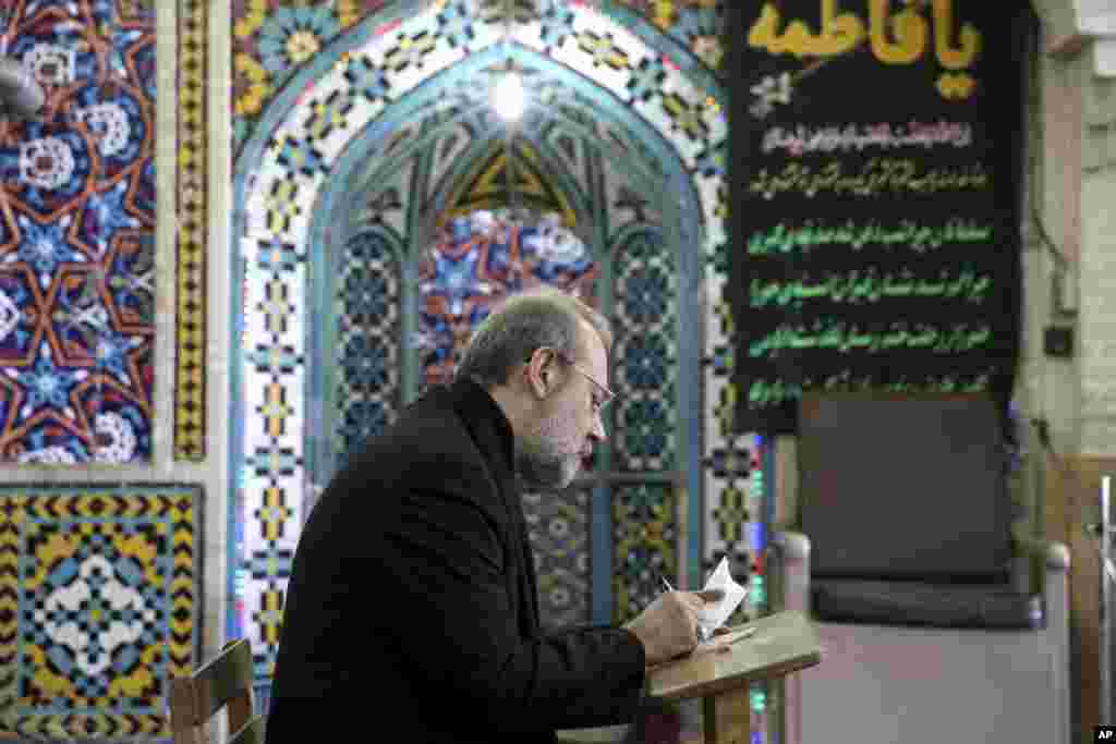 Iran&#39;s Parliament Speaker Ali Larijani votes in the parliamentary and Experts Assembly elections at a polling station in Qom, Feb. 26, 2016.