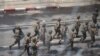 Army officers intervene during a protest against the military coup in Yangon, Myanmar, March 2, 2021. Picture taken from behind a window. REUTERS/Stringer