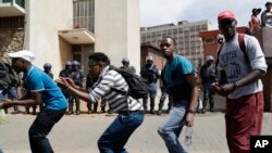 South Africa University Protests: Protesting students from the University of the Witswatersrand sing outside the Hillbrow Magistrate’s Court in Johannesburg, South Africa, Wednesday, Oct. 12, 2016, in support of their peers who were arrested earlier this week.