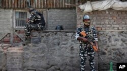 Indian paramilitary soldiers stand guard outside the main telephone exchange building in Srinagar, Indian-controlled Kashmir, Sept. 5, 2019.