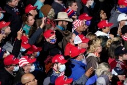 Supporters listens as President Donald Trump speaks at a campaign rally for Senate Republican candidates, Sen. Kelly Loeffler, R-Ga., and Sen. David Perdue, R-Ga., at Valdosta Regional Airport, Dec. 5, 2020, in Valdosta, Ga.