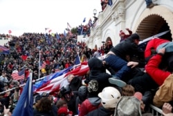 FILE - Pro-Trump protesters storm into the U.S. Capitol during a rally to contest the certification of the 2020 presidential election results by the U.S. Congress, in Washington, Jan. 6, 2021.