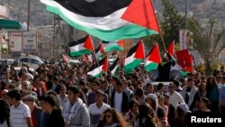 Israeli Arab demonstrators take part in a Land Day rally in the northern village of Araba, March 30, 2014. 