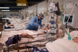 Nurse Fabiana de Oliveira works during the New Year at a field hospital set up at a sports gym to treat patients suffering with the coronavirus disease (COVID-19) in Santo Andre, Sao Paulo state, Brazil, Jan. 1, 2021.
