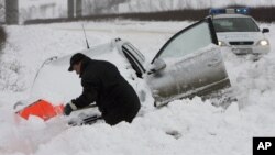 Un homme tente d'enlever la neige couvrant sa voiture près du village de Vetrino, en Bulgarie, pays européen avec le nombre de morts le plus élevé sur les routes, le jeudi 3 janvier 2008.