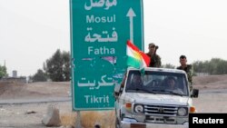 FILE - Members of the Kurdish security forces take part in an intensive security deployment on the outskirts of Kirkuk, June 12, 2014.
