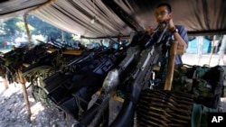 FILE - Weapons belonging to rebels of the Revolutionary Armed Forces of Colombia (FARC) are stored at a rebel camp in La Carmelita near Puerto Asis in Colombia's southwestern state of Putumayo, Feb. 28, 2017.