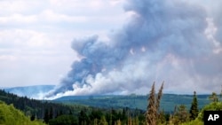 FILE - Smoke billows from the Donnie Creek wildfire burning north of Fort St. John, British Columbia, Canada, Sunday, July 2, 2023. (AP Photo/Noah Berger, File)