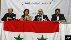 A man, holding a national flag with a poster of Turkey&#39;s founder Kemal Ataturk, watches as thousands of Turks clash with security as they try to break through barricades mounted around the prison and courthouse complex in Silivri, in the outskirts of Istanbul.