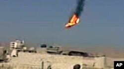 Gambar video amatir menunjukkan sebuah helikopter pemerintah Suriah terbakar dan jatuh di pinggir kota Damaskus hari Senin (27/8).