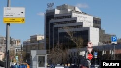 FILE - A view shows a sign with the logo of SAP software company on the roof of an office building in Moscow, April 23, 2018.