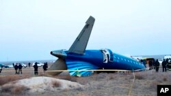 FILE - In this photo taken from a video released by the administration of Mangystau region, a part of Azerbaijan Airlines' Embraer 190 lies on the ground near the airport of Aktau, Kazakhstan, Dec. 26, 2024.