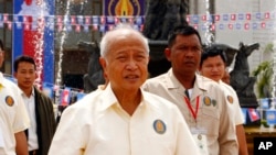 FILE PHOTO - Cambodia's Prince Norodom Ranariddh, foreground, of royalist Funcinpec party walks after his party's congress in Phnom Penh, Cambodia, Monday, Jan. 19, 2015. (AP Photo/Heng Sinith)
