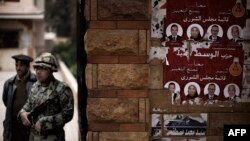 An Egyptian soldier and a policeman stand in the Dokki neighborhood of Cairo, Feb. 14, 2012. Egyptian police raided the office of a news website late Tuesday and arrested its editor-in-chief, who reportedly is being held at Dokki police station.