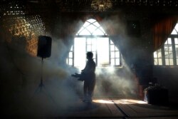A firefighter disinfects the shrine of Saint Saleh to help prevent the spread of the new coronavirus in northern Tehran, Iran, March, 6, 2020.