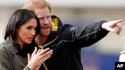 FILE - Britain's Prince Harry and his fiancee Meghan Markle attend the UK team trials for the Invictus Games Sydney 2018 at the University of Bath in Bath, England, April 6, 2018. 