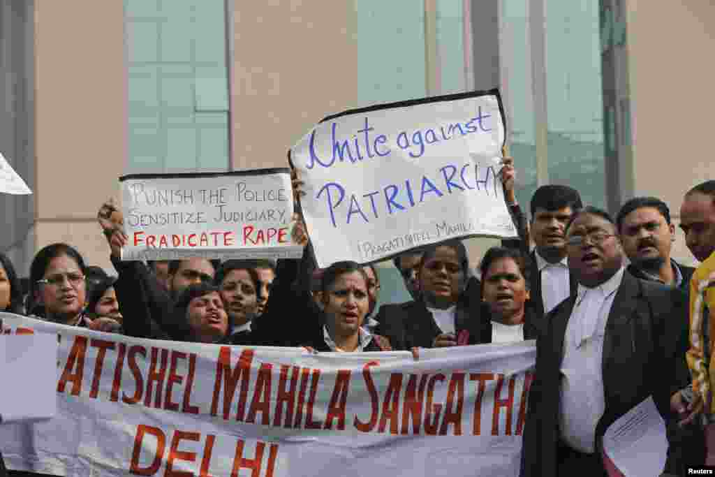 Lawyers shout slogans as they hold placards and a banner during a protest demanding the judicial system act faster against rape outside a district court in New Delhi, India, January 3, 2013.