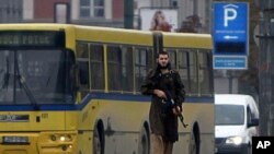 A gunman with an automatic weapon walks in Sarajevo, after he fired shots at the US embassy, October 28, 2011.