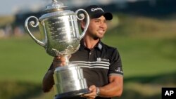 Jason Day, of Australia, holds up the Wanamaker Trophy after winning the PGA Championship golf tournament Sunday, Aug. 16, 2015, at Whistling Straits in Haven, Wis.