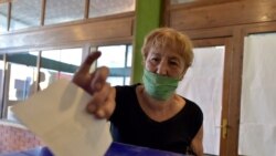 A woman casts her ballot for a parliamentary elections at a polling station in Cetinje, Aug. 30, 2020. Voters in Montenegro on Sunday cast ballots in a tense election that is pitting the long-ruling pro-Western party against the opposition seeking…