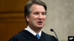 In this Aug. 7, 2018, photo. President Donald Trump's Supreme Court nominee, Judge Brett Kavanaugh, officiates at the swearing-in of Judge Britt Grant to take a seat on the U.S. Court of Appeals for the Eleventh Circuit in Atlanta at the U.S. District Courthouse in Washington.