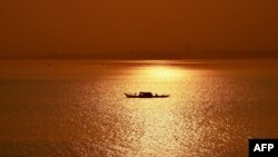 រូបឯកសារ៖ ទិដ្ឋភាពនៃទូកនេសាទមួយបរនៅលើផ្ទៃទន្លេមេគង្គពេលថ្ងៃរះ នៅទីក្រុងភ្នំពេញ កាលពីថ្ងៃទី២៩ ខែមករា ឆ្នាំ២០១៩។