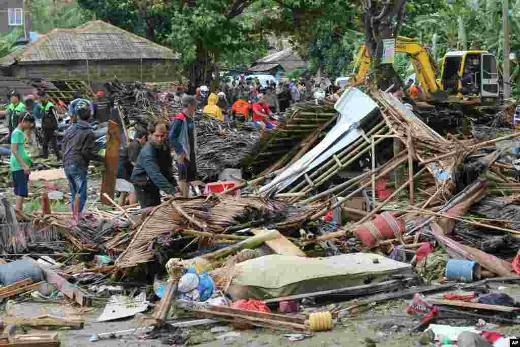 Residents inspect a house damaged by a tsunami, in Carita, Indonesia, Dec. 23, 2018. The tsunami apparently caused by the eruption of an island volcano killed a number of people around Indonesia's Sunda Strait.