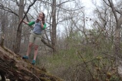 FILE - Jordan Miller, 11, watches birds in her backyard in Manlius, N.Y., April 25, 2020, after her Girl Scout troop's group outing to a New York state park was canceled because of the coronavirus disease outbreak.