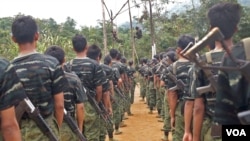 FILE - Arakan Army recruits scale the climbing ropes at the Laiza, Kachin state base camp.