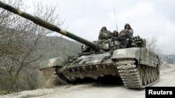 A tank of the self-defense army of Nagorno-Karabakh moves on the road near the village of Mataghis, April 6, 2016. 