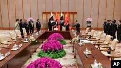FILE - Pakistani Prime Minister Imran Khan, back second from left, speaks with Chinese Premier Li Keqiang, back third from left, during a signing ceremony at the Diaoyutai State Guesthouse in Beijing, April 28, 2019. 
