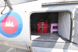 A box containing swab samples from passengers and crew of the Westerdam cruise ship sits in a helicopter before being transported to Phnom Penh for testing, in Sihanoukville, Cambodia, Feb. 13, 2020.