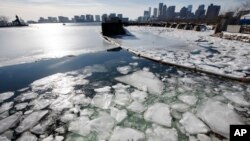 Sea ice floats in Boston Harbor Jan. 3, 2018, in Boston. After a week of frigid temperatures, a major winter storm is predicted for the region on Thursday. 
