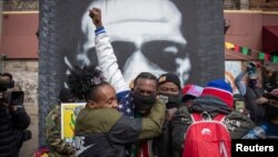 Local residents embrace after the verdict in the trial of former Minneapolis police officer Derek Chauvin, found guilty of the death of George Floyd, at George Floyd Square in Minneapolis, Minnesota, U.S. April 20, 2021. (REUTERS/Adrees Latif)