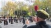 A veteran records a band with his phone as Australian military personnel, past and present, commemorate ANZAC Day during a march through the city center in Sydney, Australia, April 25, 2021. Many Australians and New Zealanders consider it one of the most sacred days of the year.