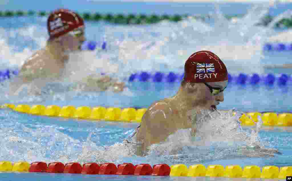 Britain's Adam Peaty goes on to break the world record in a heat of the men's 100-meter breaststroke during the swimming competitions at the 2016 Summer Olympics, in Rio de Janeiro, Brazil, Aug. 6, 2016.
