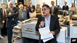 Reporters and editors gather in the The Washington Post newsroom in Washington, April 14, 2014, as contributing writer Barton Gellman describes the effort that went into a series of stories on the government’s massive surveillance program based on informa