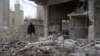 A man inspects a damaged house after an airstrike on al-Yadouda village, in Deraa Governorate, Syria, Feb. 15, 2017.
