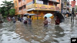 People wade through a flooded street in Chennai, in the southern Indian state of Tamil Nadu, Dec. 2, 2015. 